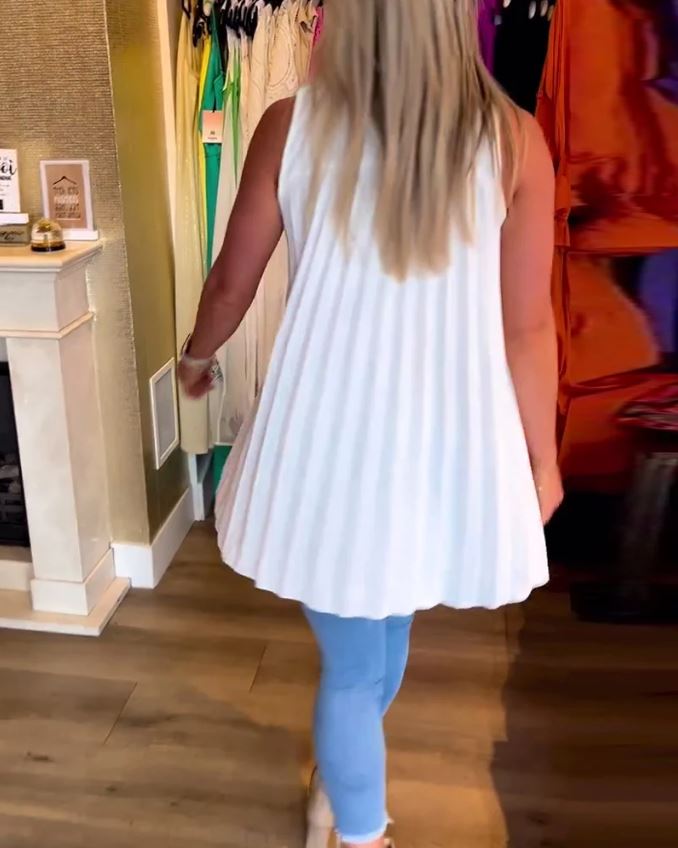 Sleeveless top with ruffles and cuffs